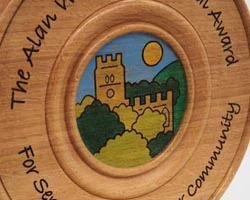 Coloured, pyrographed image on a trophy